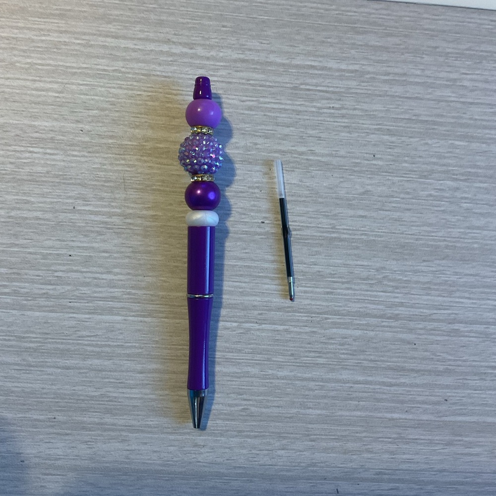 Purple customized retractable pen with an extra ink cartridge already